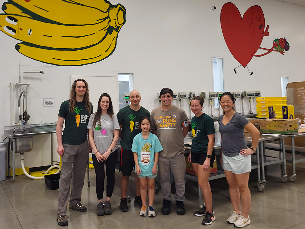 Ly with group of volunteers and CTFB staff in SORT warehouse